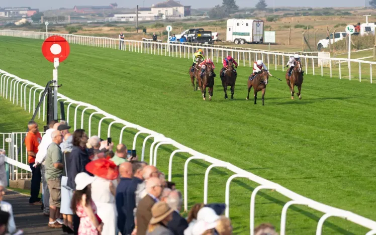 Horses race down the flat track at Great Yarmouth