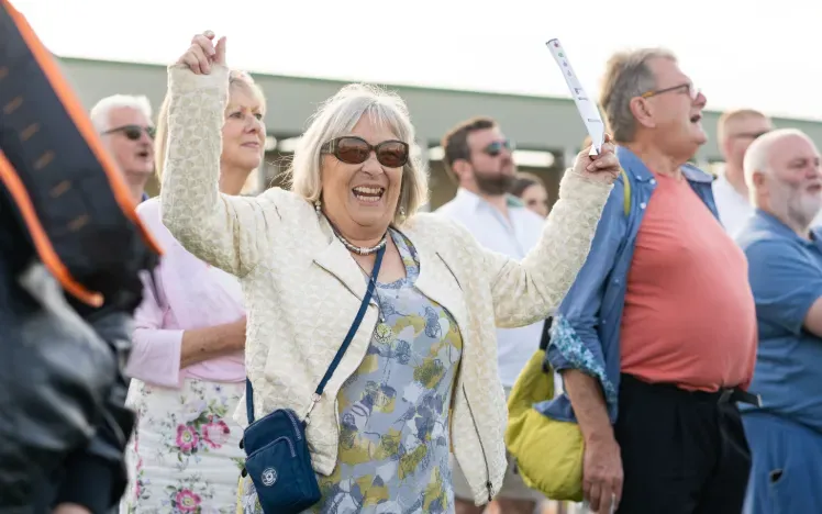 A racegoer cheers a win at Great Yarmouth Racecourse