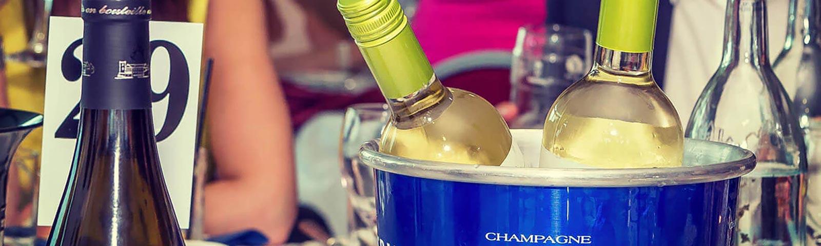Bottles of Champagne cool off in a bucket of ice