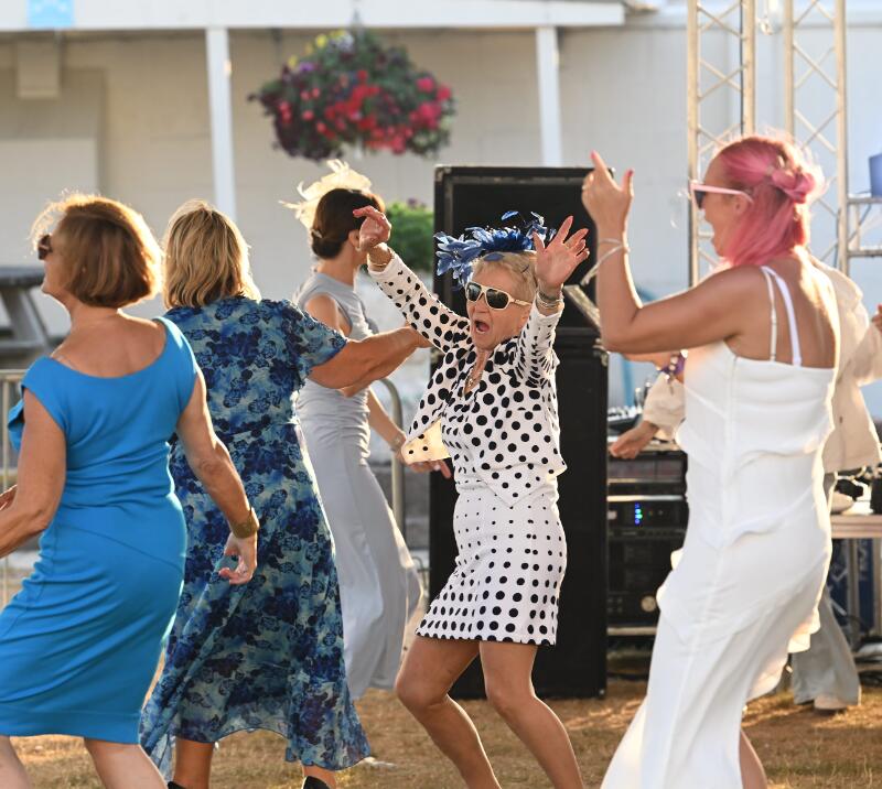 A group of race goers dancing to music at Great Yarmouth Races