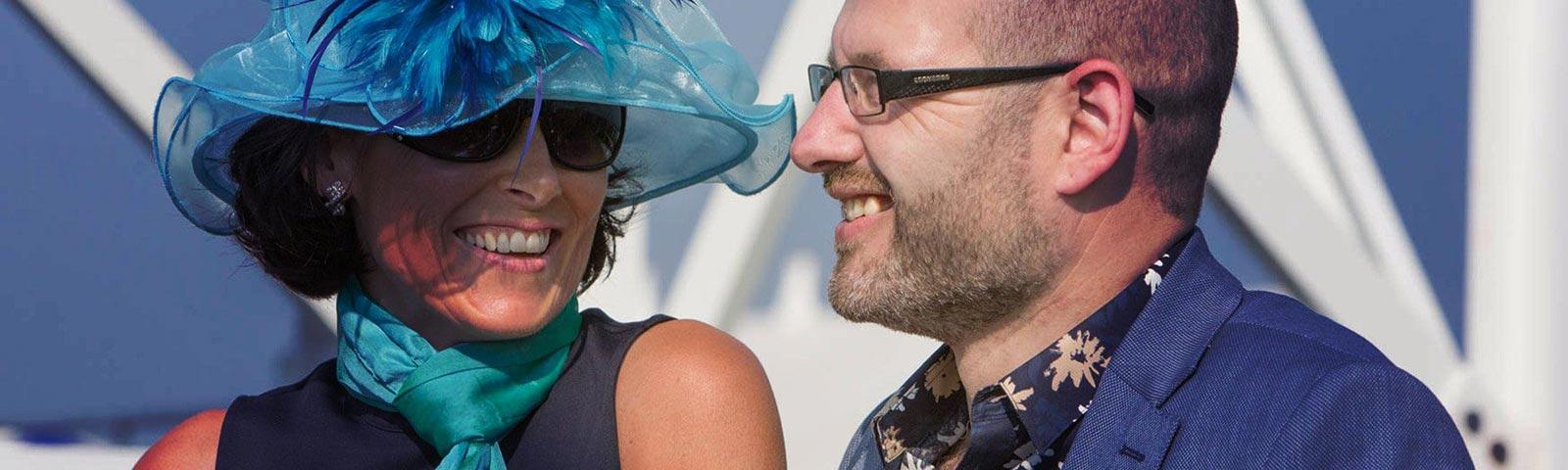 A Lady and Gentleman appear to be having a great day out in the sun at Great Yarmouth Racecourse.