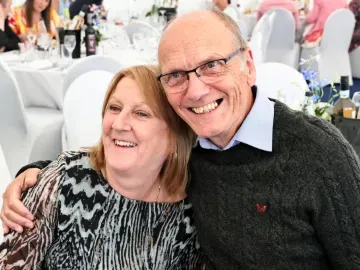 Two hospitality guests at Great Yarmouth races smile and hug for the camera