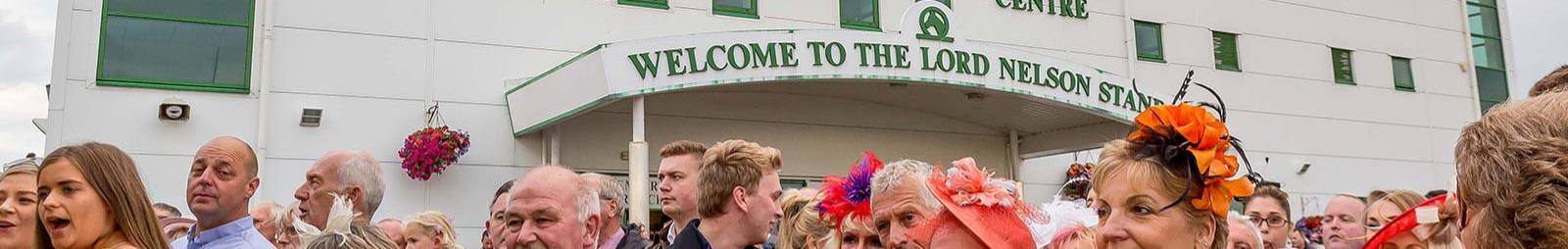 Crowds standing in front of the Lord Nelson Stand at Great Yarmouth Racecourse.