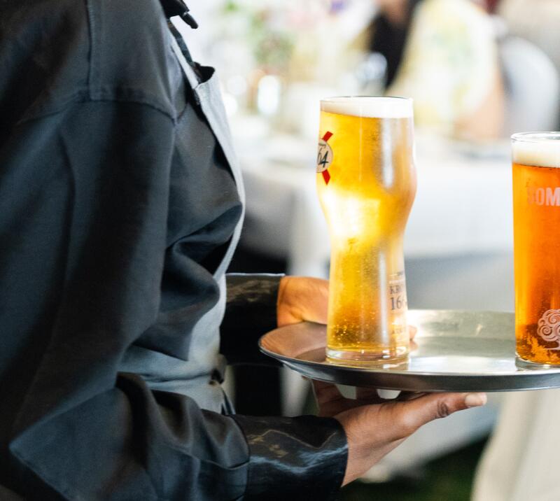 A member of waiting staff at Great Yarmouth races carries drinks for hospitality guests