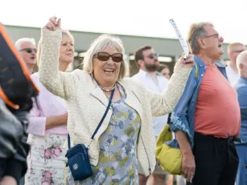 A racegoer cheers a win at Great Yarmouth Racecourse