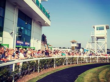 Crowds lined up next to the Parade Ring at Great Yarmouth Racecourse.