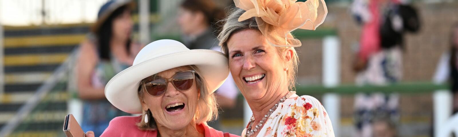 Two ladies smiling for a photo at Great Yarmouth Racecourse