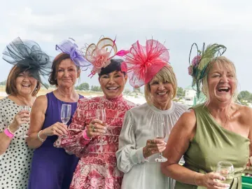A group of women dressed spectacularly for the races at Great Yarmouth