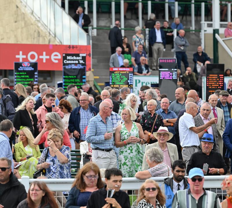 Crowds at Great Yarmouth Races in front of the betting boards and Tote